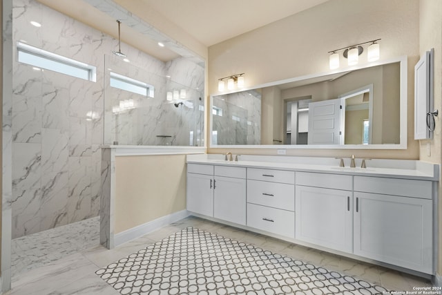 bathroom with vanity and tiled shower