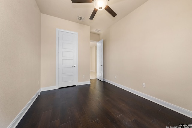 spare room featuring ceiling fan and dark hardwood / wood-style floors