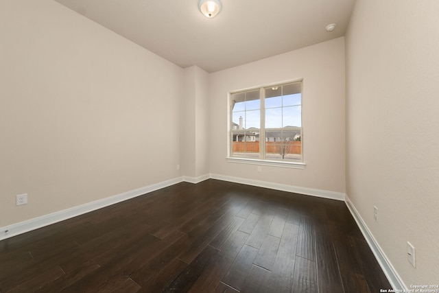 spare room featuring dark wood-type flooring