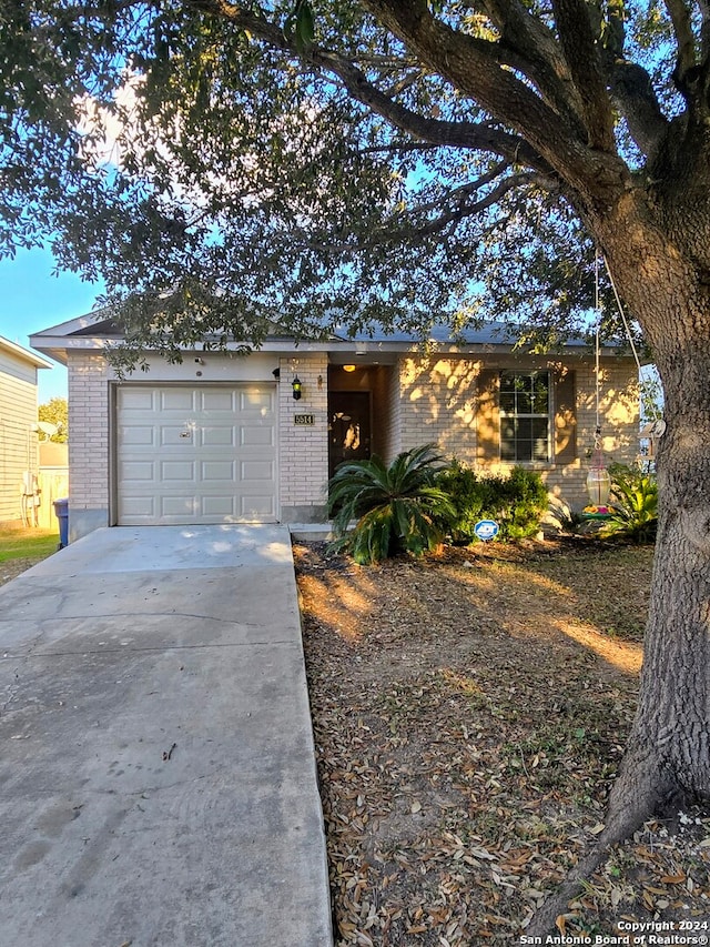 ranch-style home featuring a garage