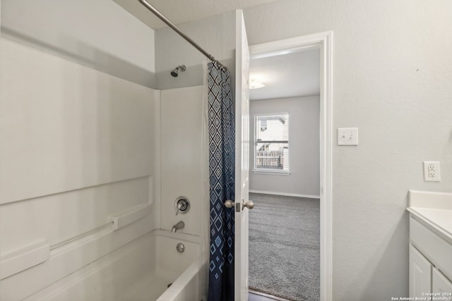 bathroom with shower / tub combo and vanity