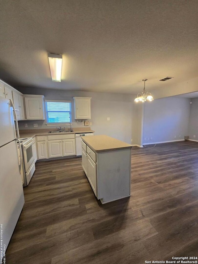 kitchen featuring sink, a kitchen island, dark hardwood / wood-style floors, white appliances, and white cabinets