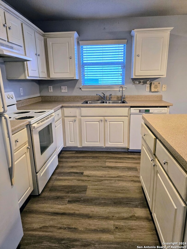 kitchen with dark hardwood / wood-style flooring, white appliances, exhaust hood, sink, and white cabinetry