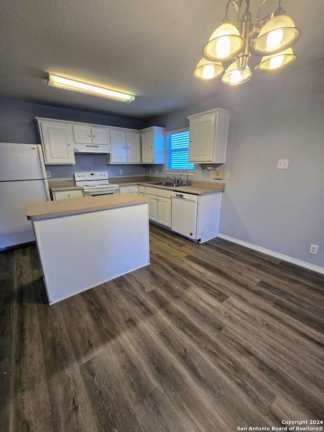 kitchen with white cabinets, pendant lighting, and white appliances