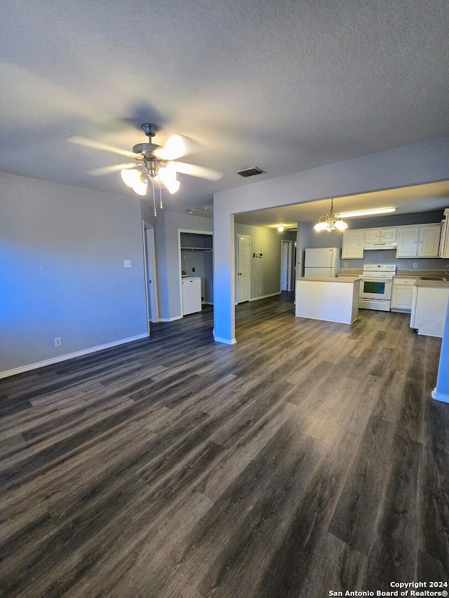 unfurnished living room with a textured ceiling, ceiling fan with notable chandelier, dark hardwood / wood-style floors, and sink