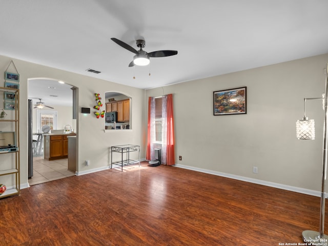 spare room featuring light hardwood / wood-style floors, a healthy amount of sunlight, and ceiling fan