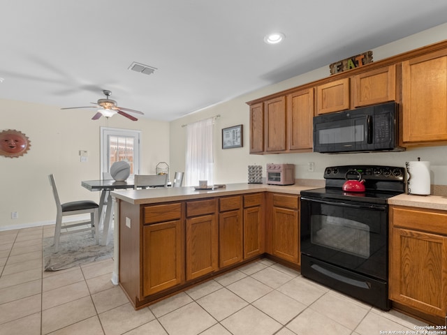 kitchen featuring ceiling fan, black appliances, light tile patterned floors, and kitchen peninsula