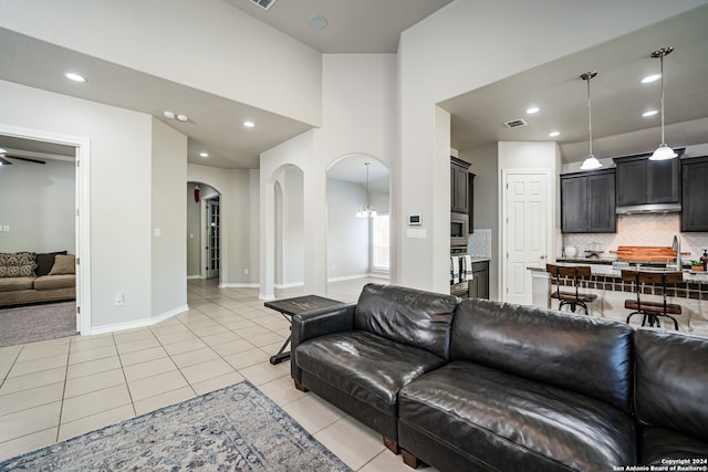 tiled living room with sink and ceiling fan