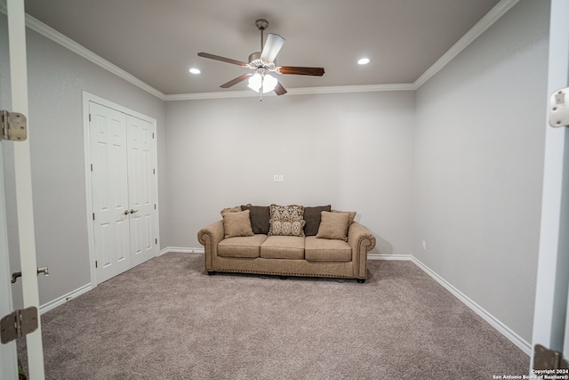 carpeted living room with crown molding and ceiling fan