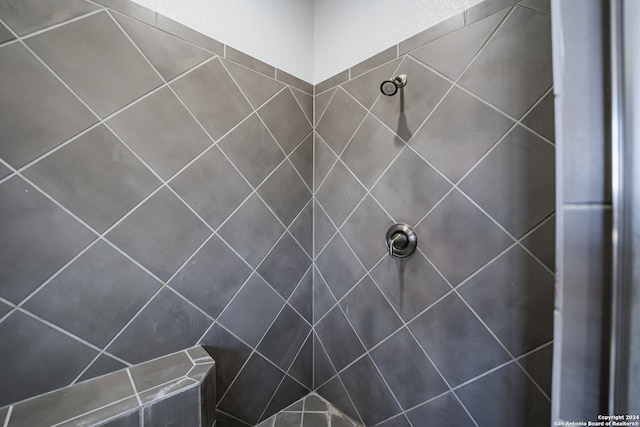 bathroom with a tile shower