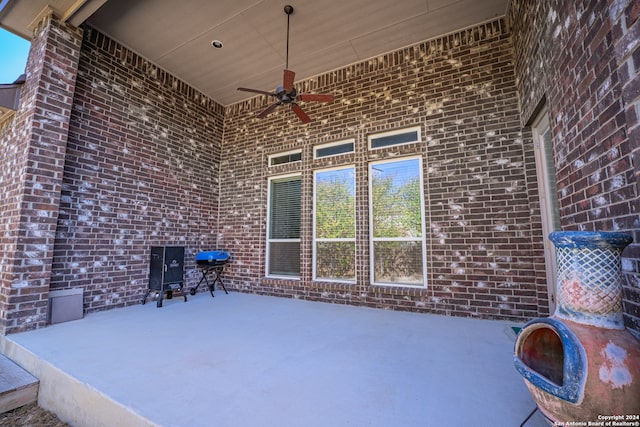 view of patio with a grill and ceiling fan