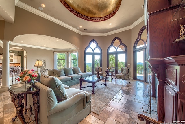 living room with ornate columns and crown molding