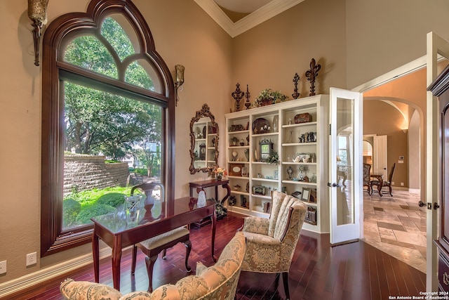 interior space with crown molding, wood-type flooring, french doors, and a high ceiling