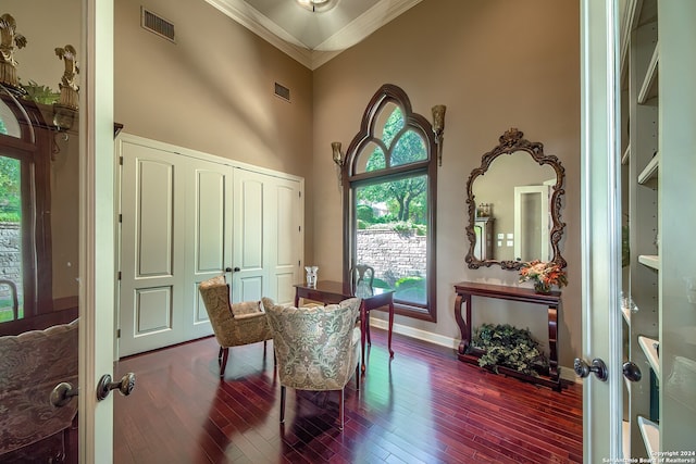 living area with ornamental molding, french doors, hardwood / wood-style floors, and a high ceiling