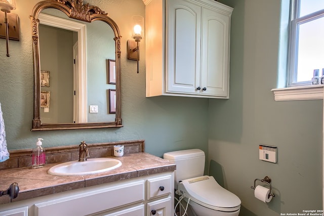 bathroom featuring vanity and toilet