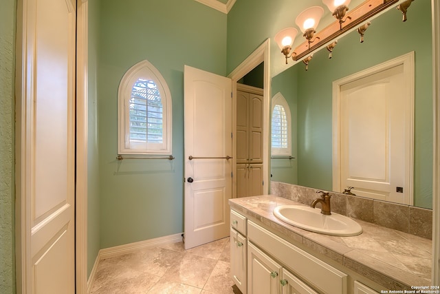 bathroom with vanity, crown molding, and tile patterned floors