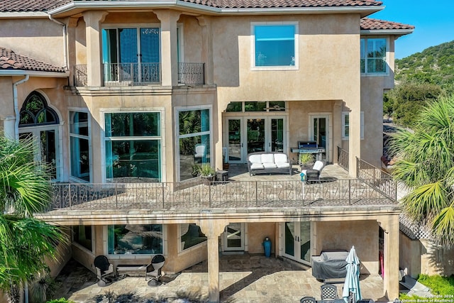 back of house with a balcony and a patio area