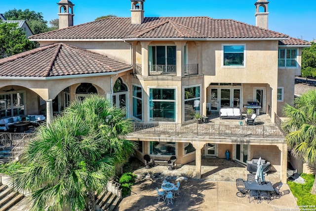 back of house featuring a patio and a balcony