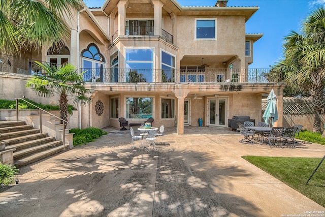 back of property featuring a patio, french doors, and a balcony