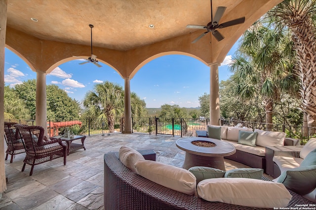 view of patio featuring an outdoor living space with a fire pit and ceiling fan