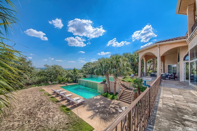 view of swimming pool with a patio area