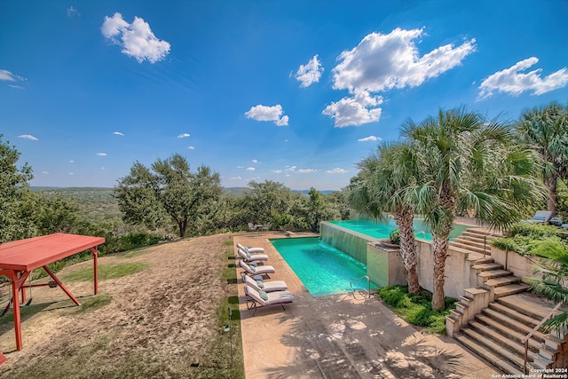 view of pool with pool water feature and a patio area