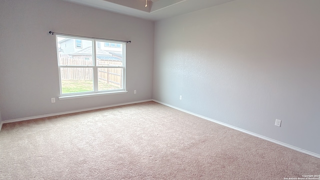 empty room with light carpet and ceiling fan