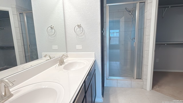 bathroom with vanity, tile patterned floors, and a shower with shower door