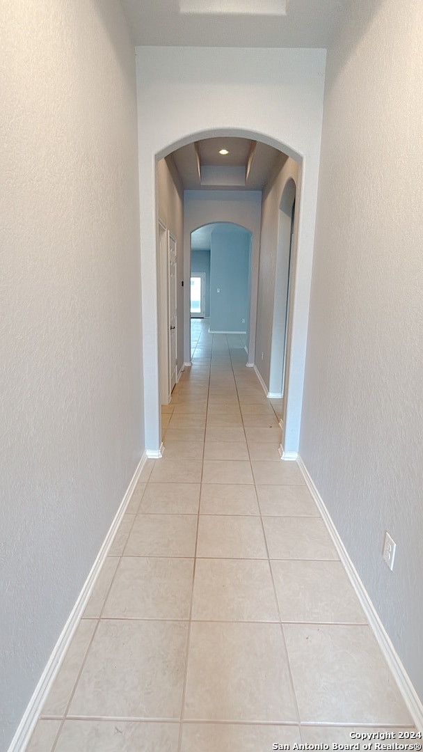 corridor with light tile patterned floors