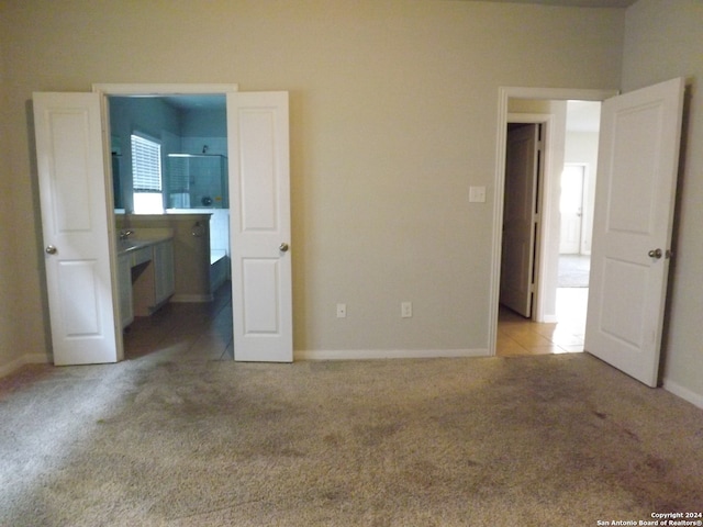 unfurnished bedroom featuring light colored carpet