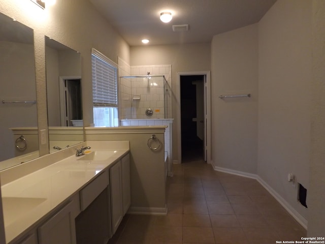 bathroom with vanity, tile patterned floors, and tiled shower