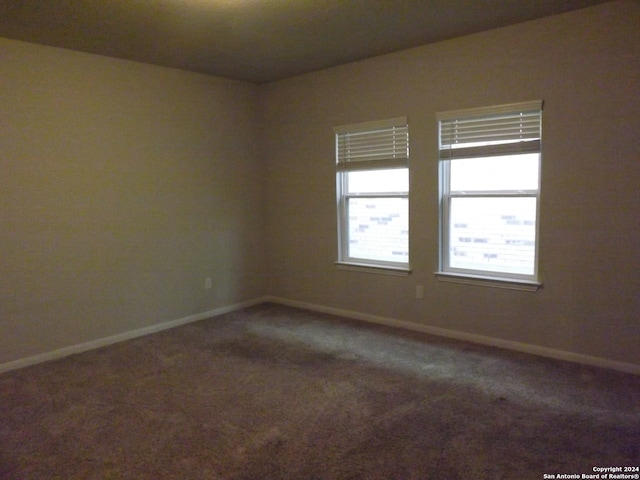 empty room featuring dark carpet