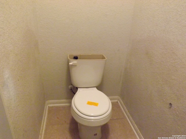 bathroom with toilet and tile patterned flooring