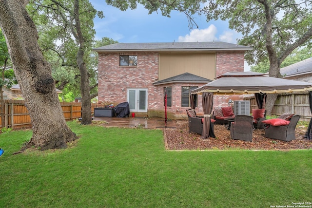 back of property featuring a gazebo, a patio area, and a yard