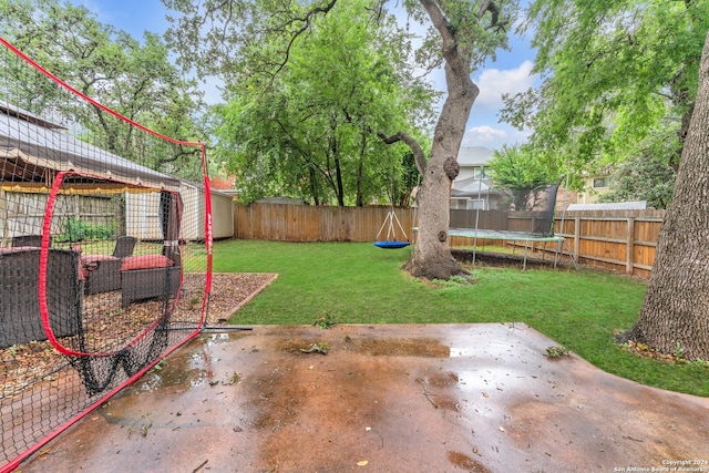 view of yard featuring a patio area and a trampoline