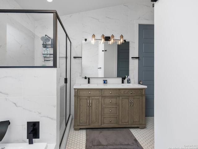 bathroom with tile walls, vanity, and walk in shower