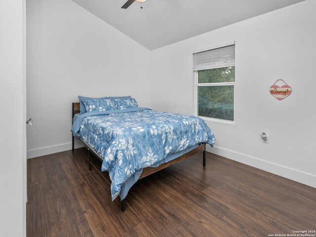 bedroom featuring ceiling fan, lofted ceiling, and dark hardwood / wood-style flooring