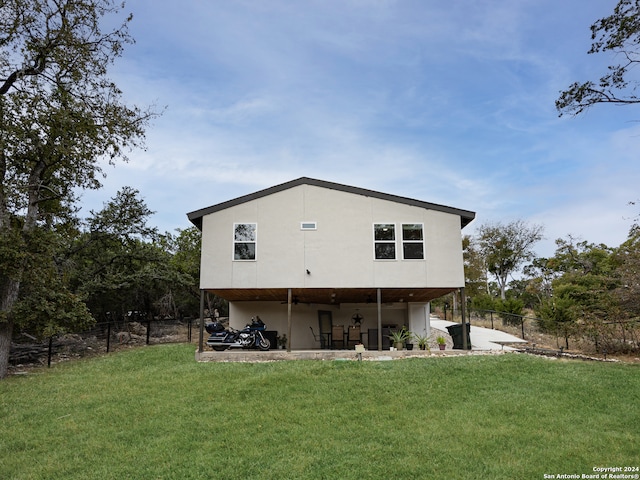 rear view of house featuring a yard