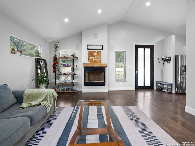 living room featuring high vaulted ceiling and dark hardwood / wood-style floors