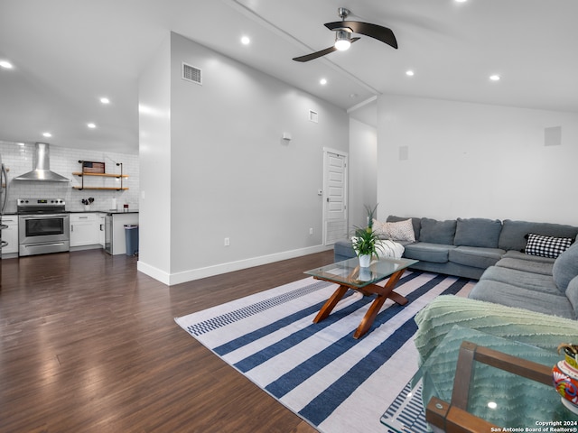 living room featuring dark hardwood / wood-style floors, high vaulted ceiling, and ceiling fan