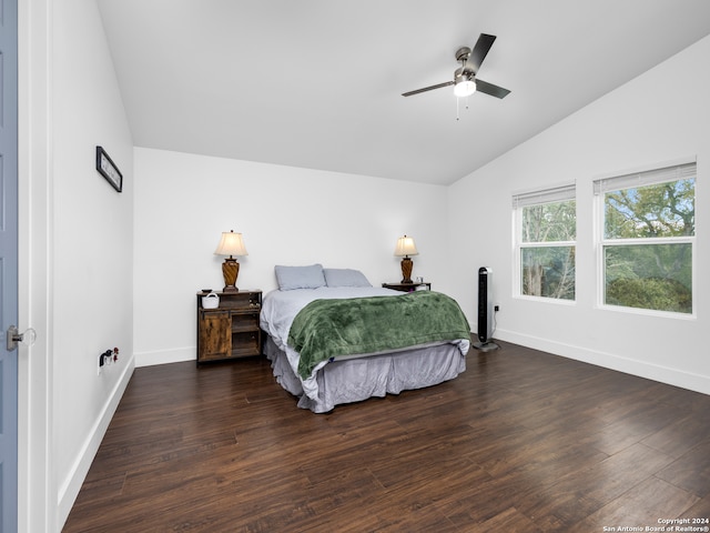 bedroom with dark hardwood / wood-style flooring, lofted ceiling, and ceiling fan