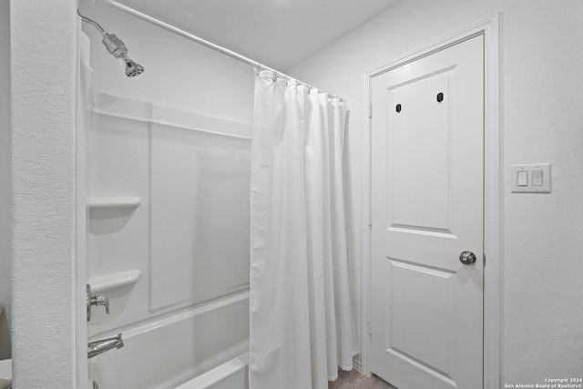 bathroom with shower / bathtub combination with curtain