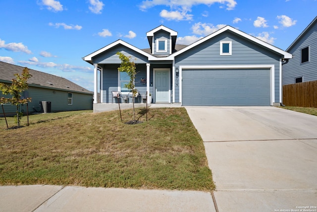 view of front of property with a front yard and a garage