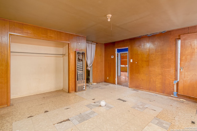 empty room featuring wood walls