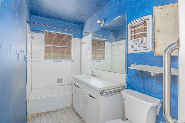 full bathroom featuring toilet, tiled shower / bath, and vanity