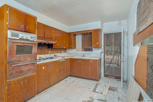 kitchen featuring sink, oven, a wealth of natural light, and white gas cooktop