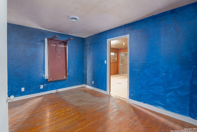 spare room with wood-type flooring