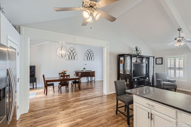 kitchen with ceiling fan with notable chandelier, white cabinetry, light hardwood / wood-style floors, pendant lighting, and stainless steel refrigerator with ice dispenser