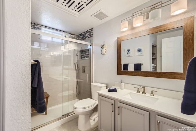 bathroom with toilet, tile patterned flooring, vanity, a textured ceiling, and an enclosed shower