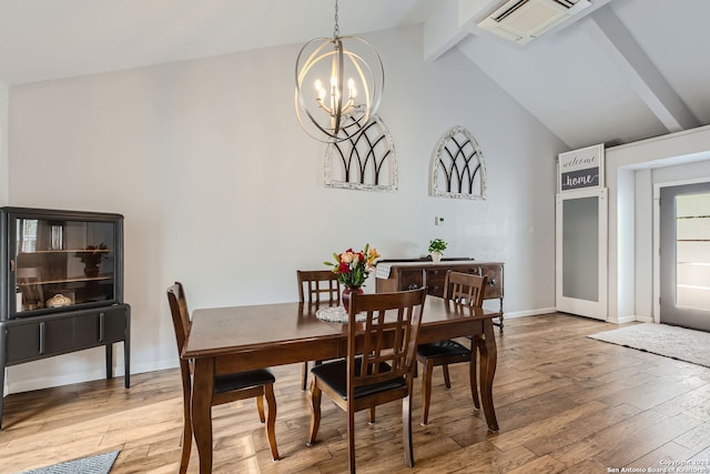 dining area featuring beamed ceiling, a notable chandelier, high vaulted ceiling, and light wood-type flooring